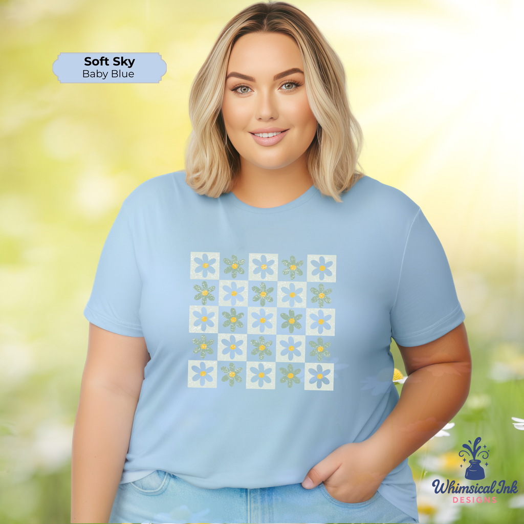 Woman wearing a light blue t-shirt with floral patterns against a blurred natural background