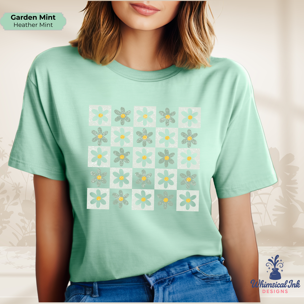 Person wearing a light green t-shirt with floral pattern, standing against a neutral background.