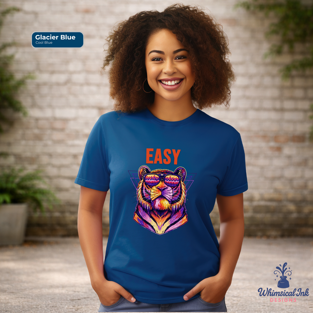 Person wearing a blue t-shirt with a colorful tiger graphic and 'EASY' text, standing against a brick wall.
