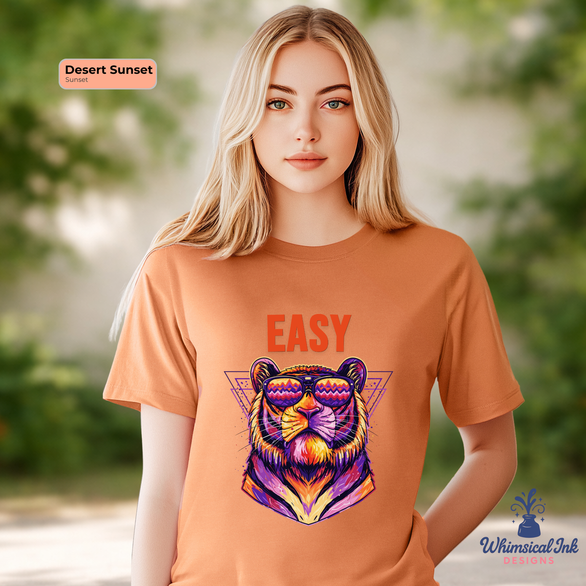 Woman wearing an orange t-shirt with a colorful tiger graphic and 'EASY' text, standing outdoors.