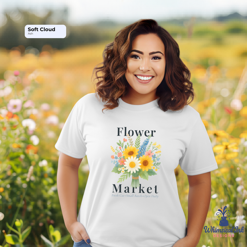 Woman wearing a 'Flower Market' t-shirt in a field of flowers with 'Whimsical Ink' branding.