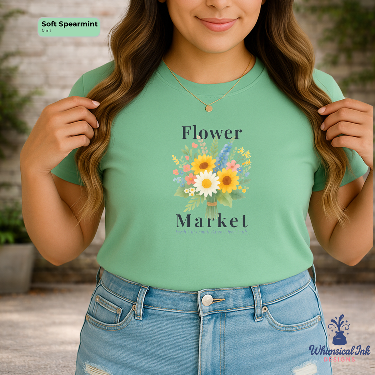 Person wearing a green t-shirt with 'Flower Market' design and 'Whimsical Ink' branding.