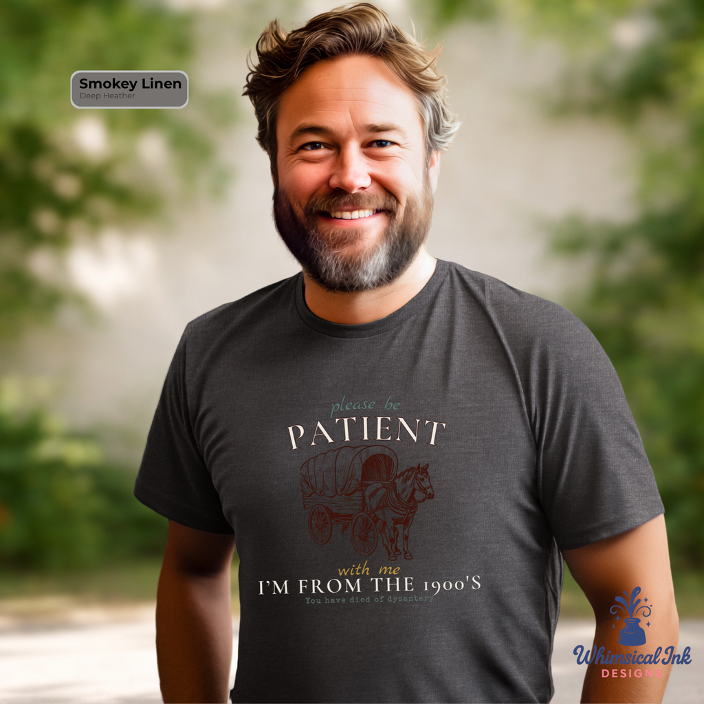 Man wearing a t-shirt with a vintage-style graphic and text, standing outdoors.