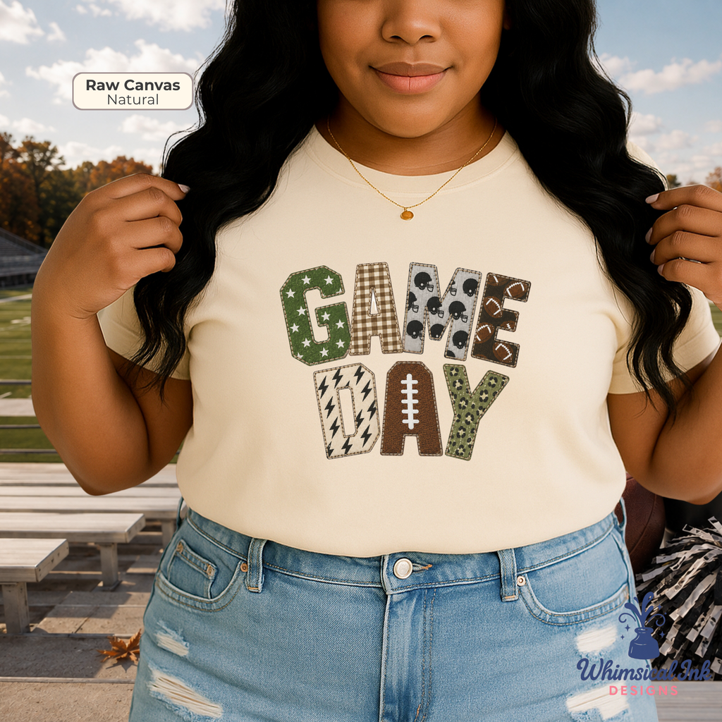 A woman wearing a cream-colored t-shirt with a 'GAME DAY' graphic made of football-themed patterned letters, paired with blue jeans in an outdoor setting.
