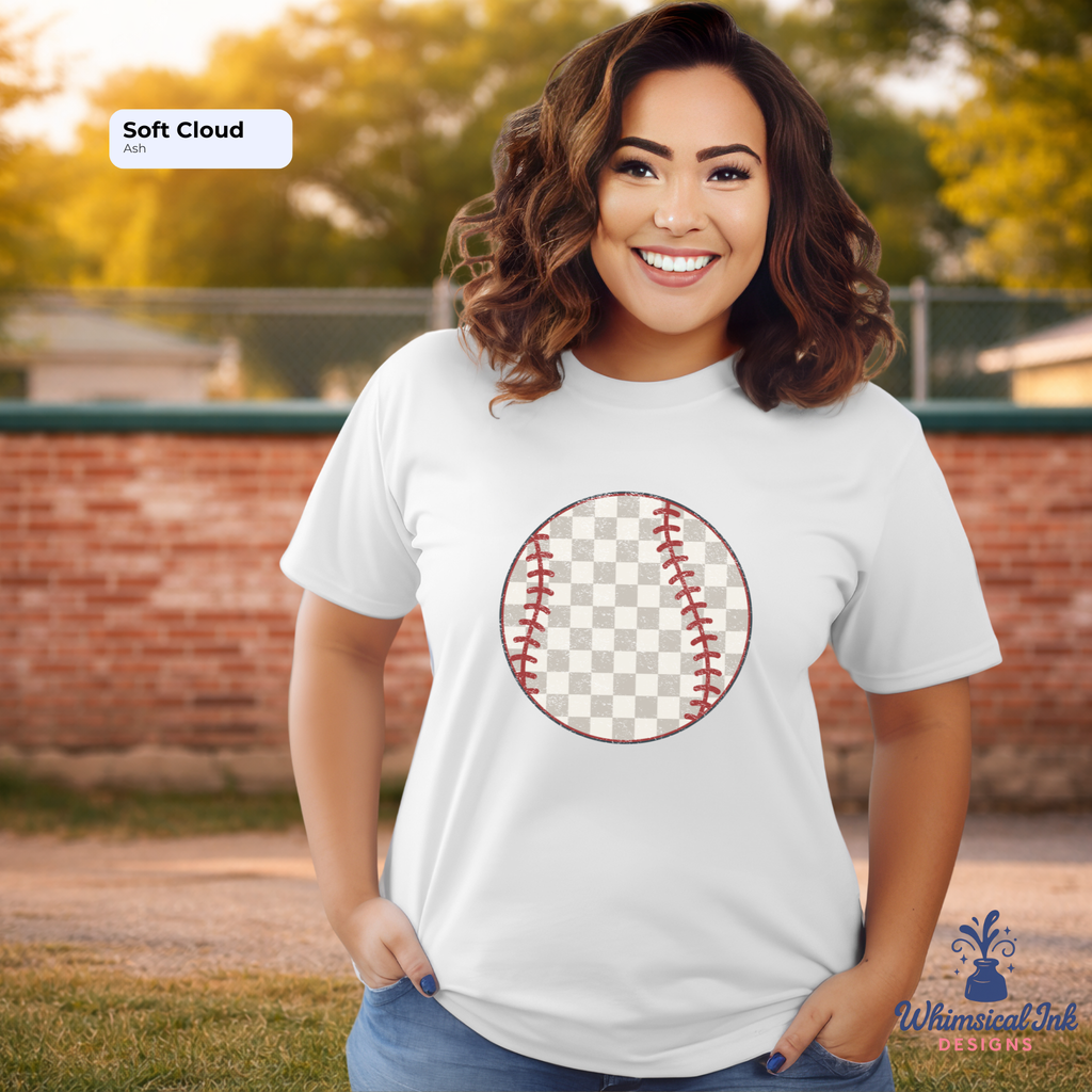 Woman wearing a white t-shirt with a baseball graphic on a sports field