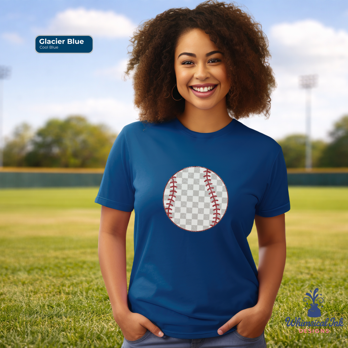 Woman wearing a blue t-shirt with a baseball graphic on a grassy field