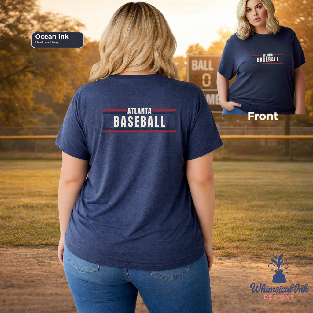 Person wearing a navy blue t-shirt with 'Atlanta Baseball' text, standing on a baseball field.