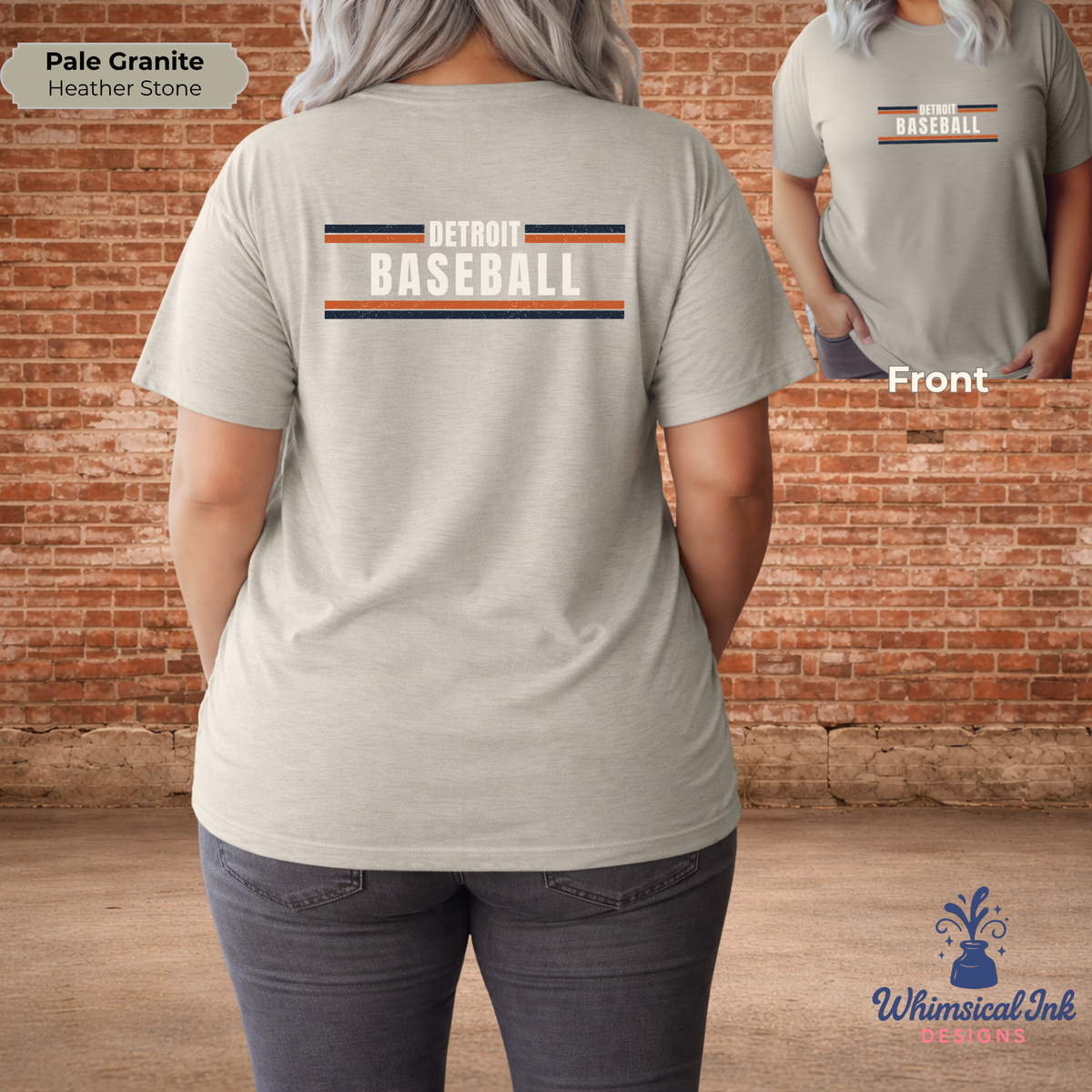 Person wearing a beige 'Detroit Baseball' t-shirt on a brick wall background.
