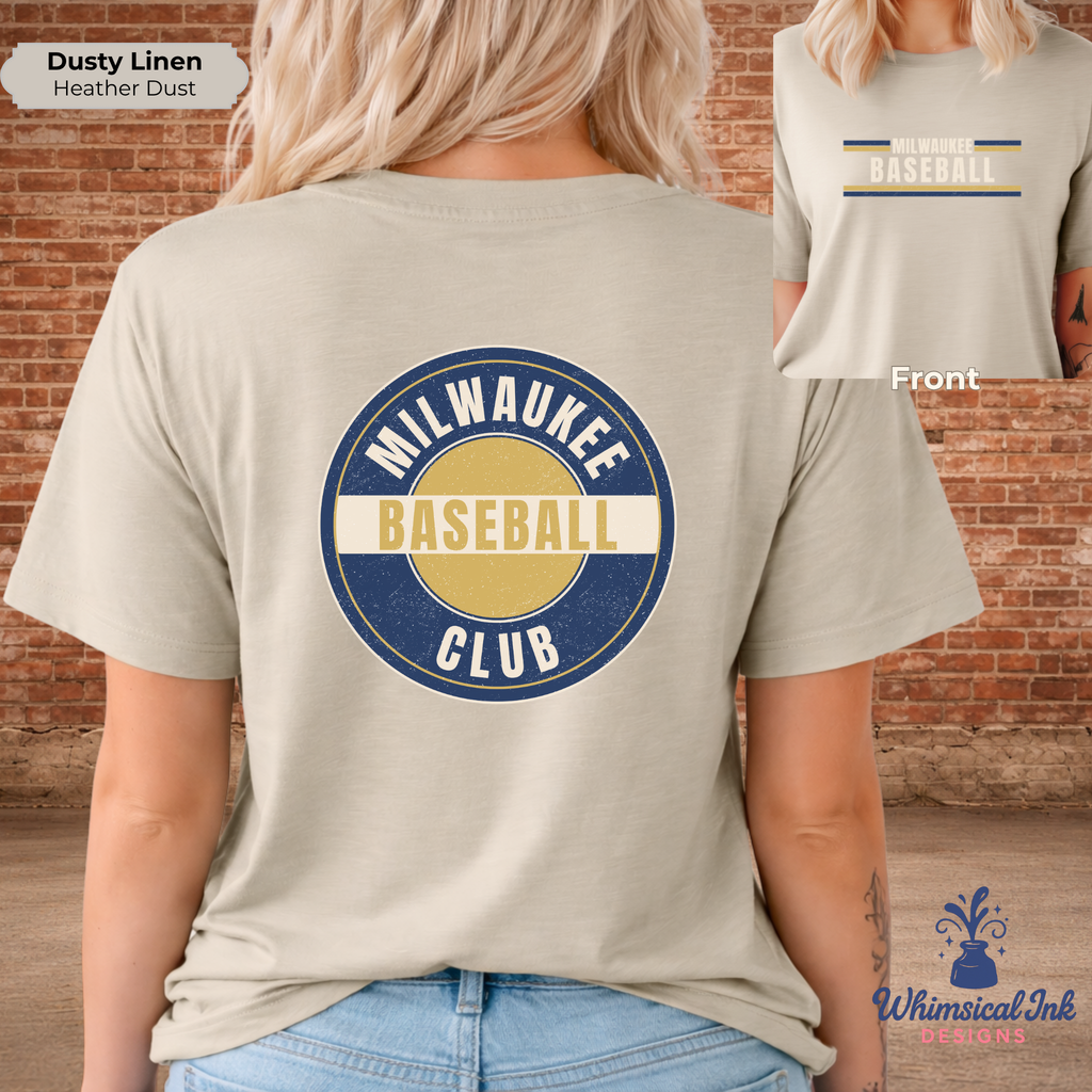Person wearing a beige t-shirt with 'Milwaukee Baseball Club' design, standing against a brick wall.