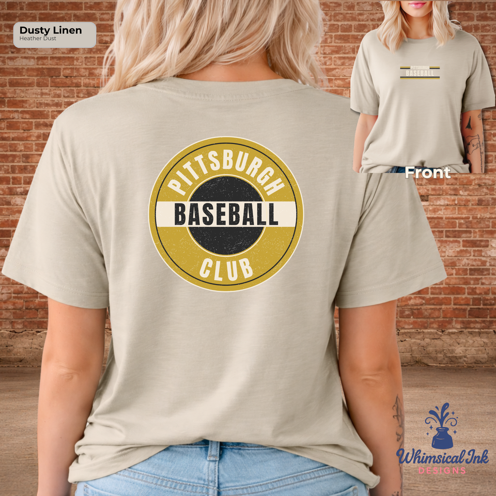Person wearing a beige t-shirt with 'Pittsburgh Baseball Club' design, standing against a brick wall.