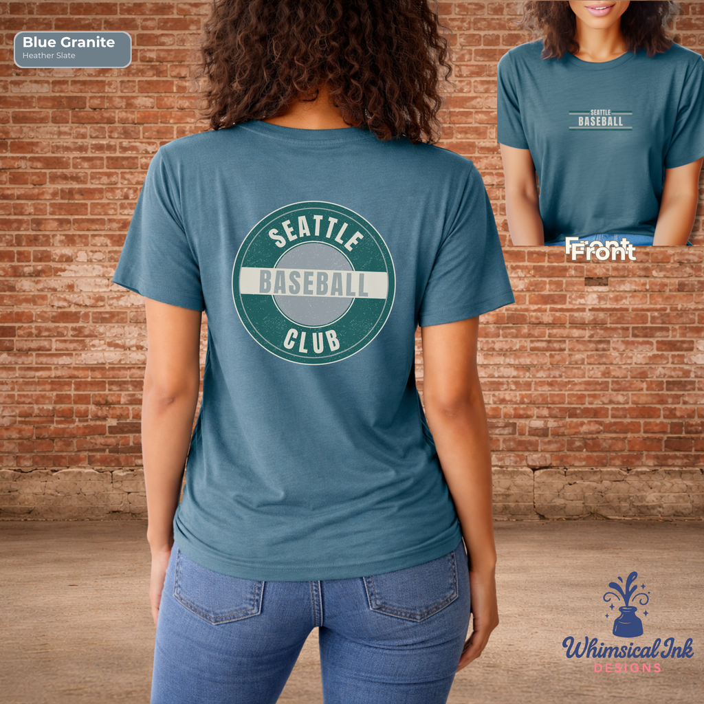 Person wearing a blue t-shirt with 'Seattle Baseball Club' design, standing in front of a brick wall.