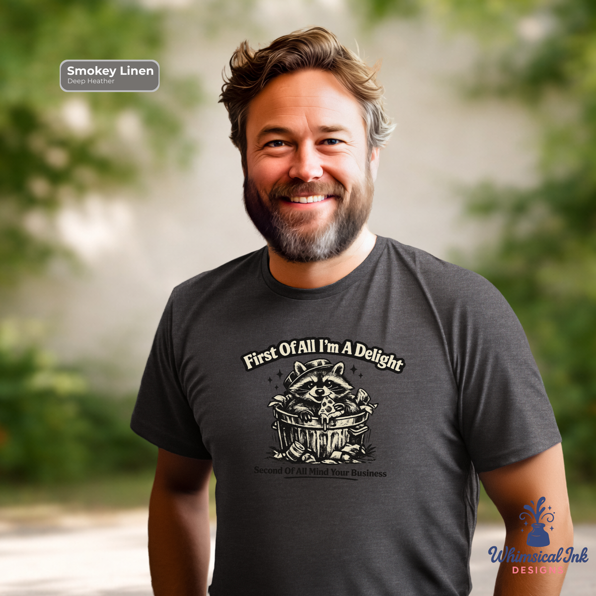 Man wearing a dark t-shirt with a graphic design and text, standing outdoors.