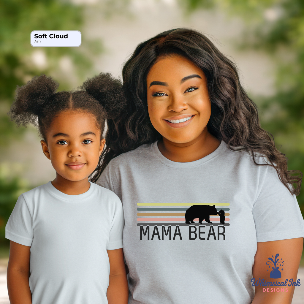 Woman and child wearing 'Mama Bear' t-shirts with a nature background
