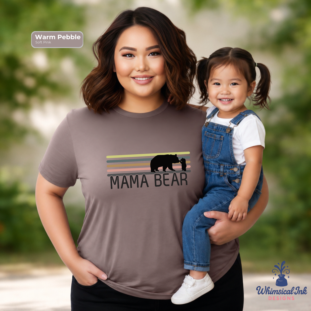 Woman wearing a 'Mama Bear' shirt holding a child outdoors.