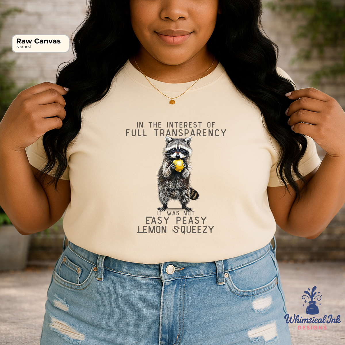 Person wearing a t-shirt with a raccoon graphic and humorous text, standing outdoors.