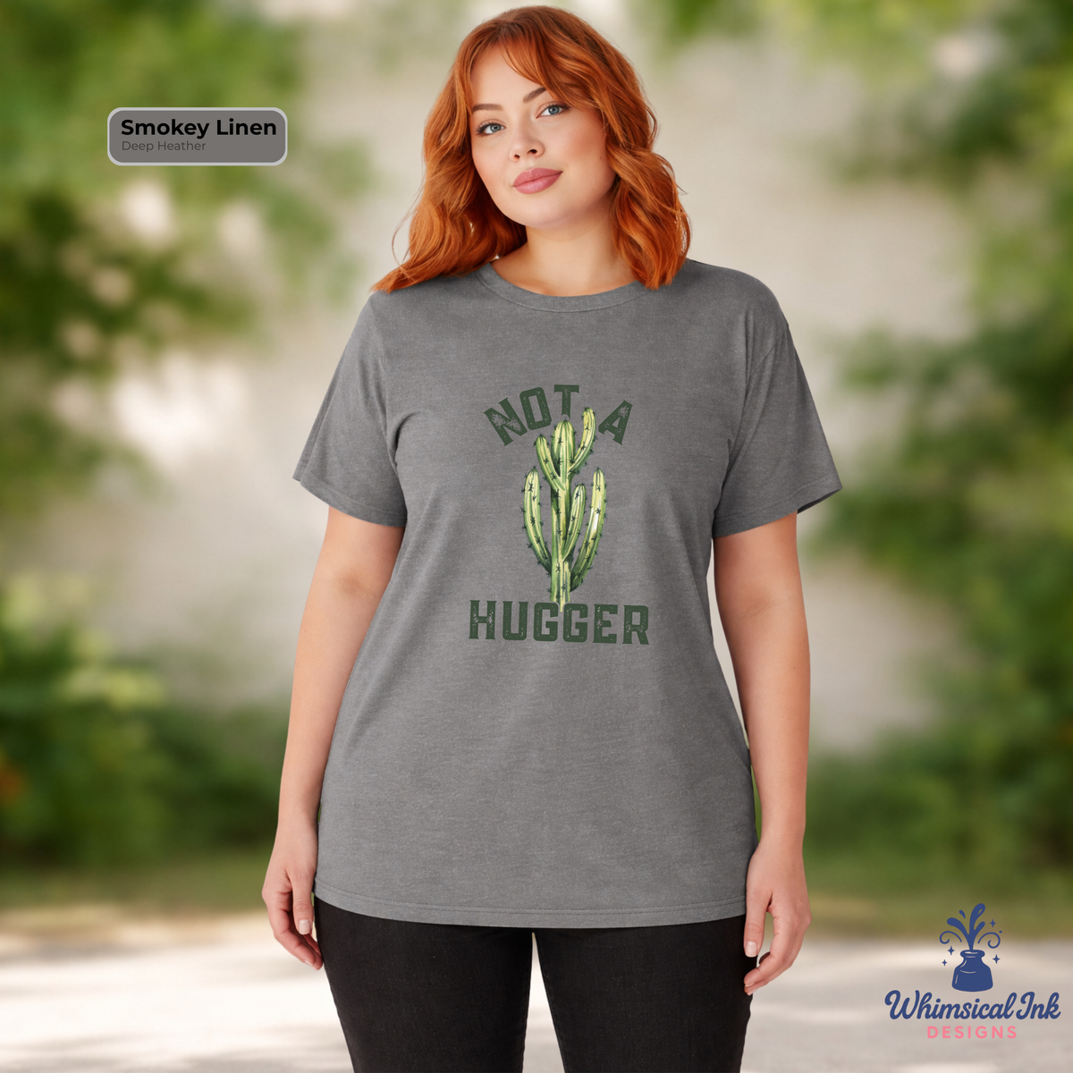 Woman wearing a gray t-shirt with a cactus graphic and text, standing outdoors.