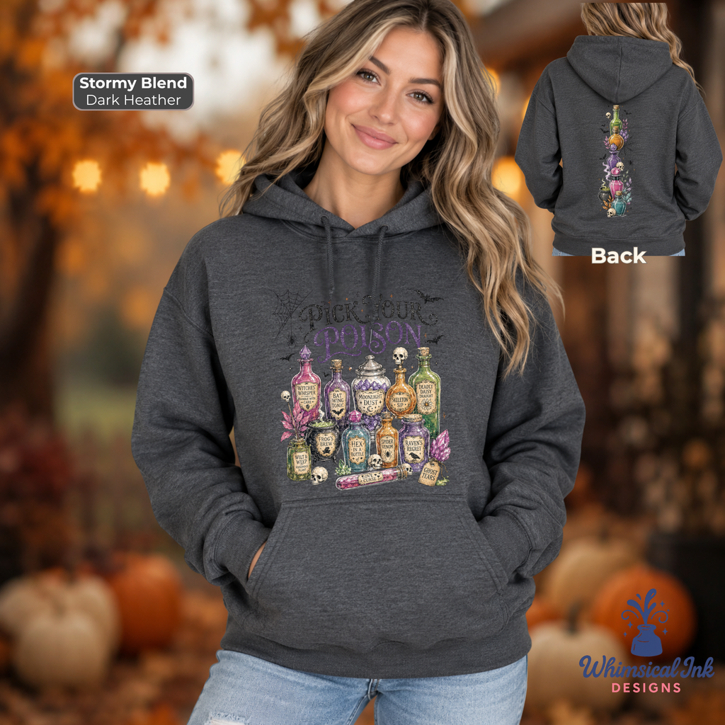 A woman models a dark heather gray hoodie with a colorful 'Pick Your Poison' potion graphic on the front, with a smaller inset showing the back of the hoodie. The background is a warm, blurred autumn scene with pumpkins.