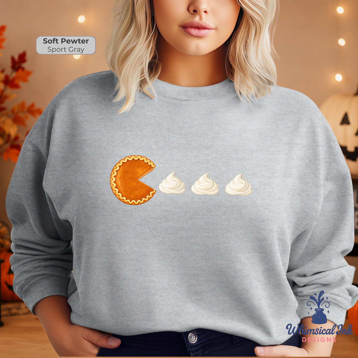 A woman wearing a light gray sweatshirt with a graphic of a pumpkin pie slice and three whipped cream dollops on the front. The text 'Soft Pewter Sport Gray' is visible in the top left corner.