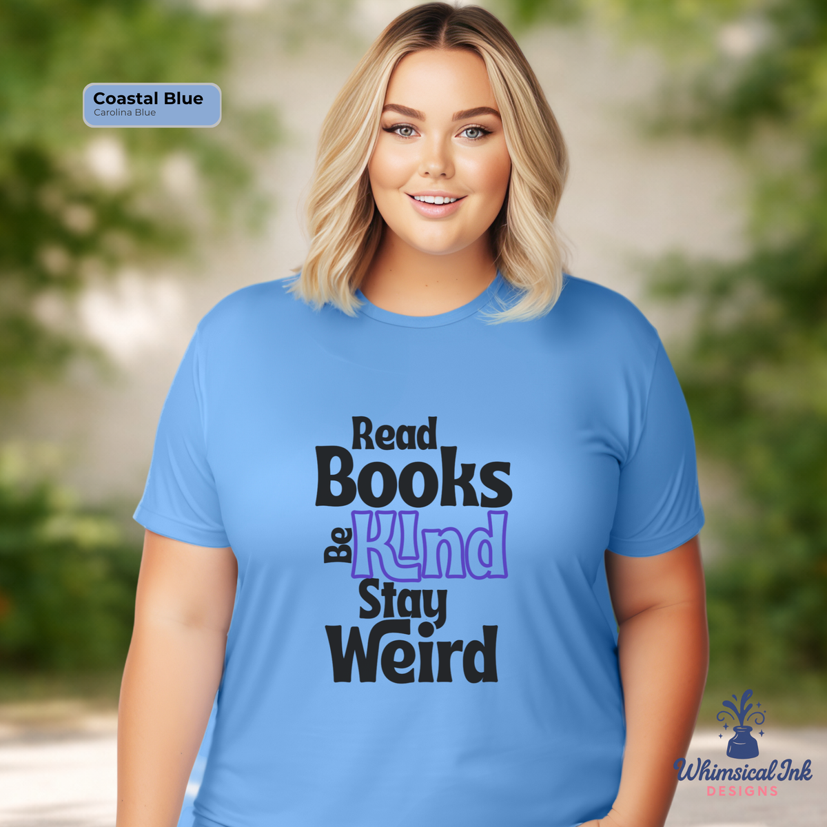 Woman wearing a blue t-shirt with text 'Read Books & Stay Weird' in a natural setting.