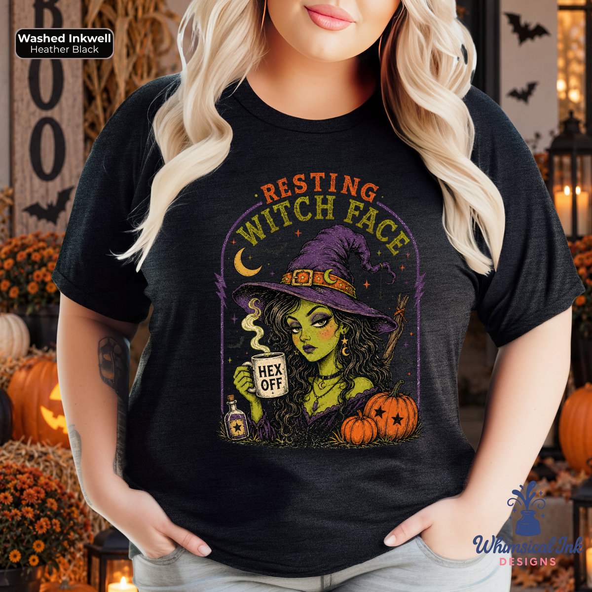 A woman wearing a black graphic t-shirt with a Halloween witch design that reads 'RESTING WITCH FACE' and 'HEX OFF'. The background is a decorated autumn scene with pumpkins and candles.